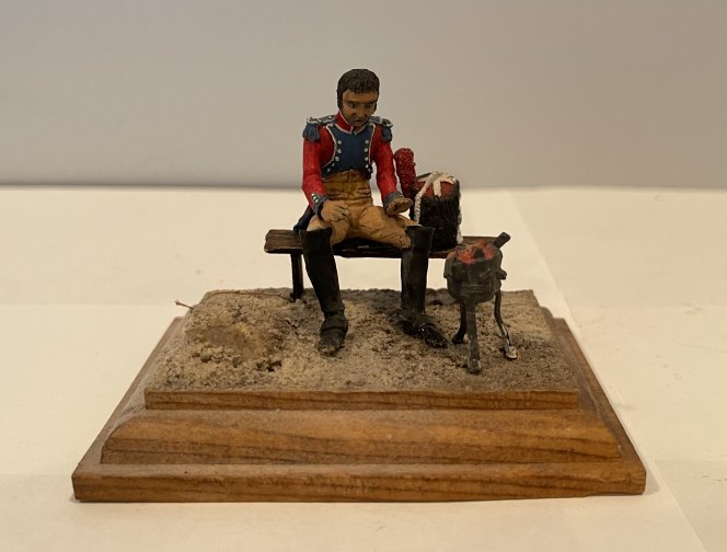 own Manufacturer. Matte finish painted figure of a Napoleonic Soldier on Bench with Camp Fire